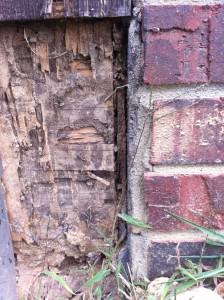 brick house with wood rot