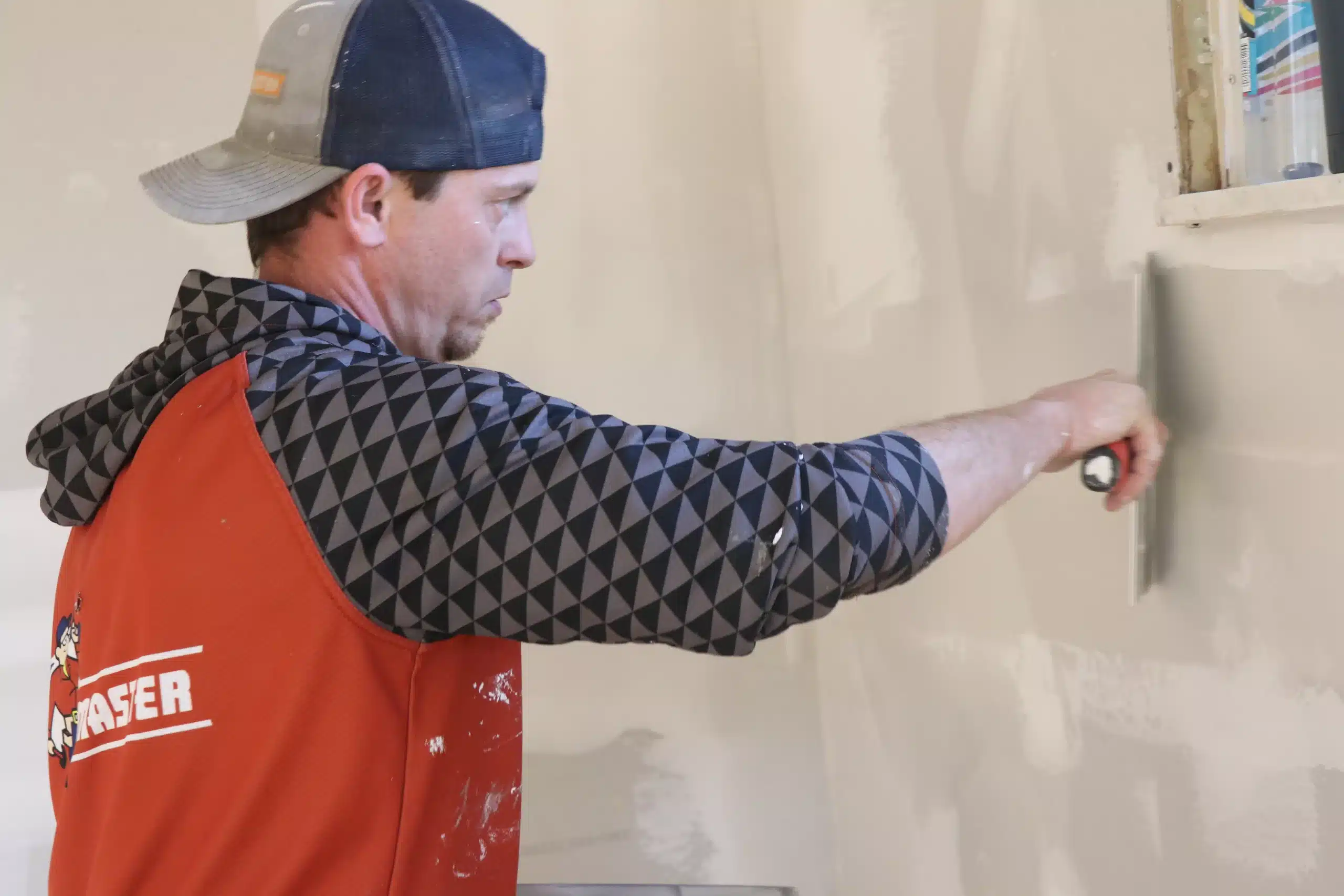 ProMaster craftsman performs drywall repairs as part of Cincinnati winter home maintenance.