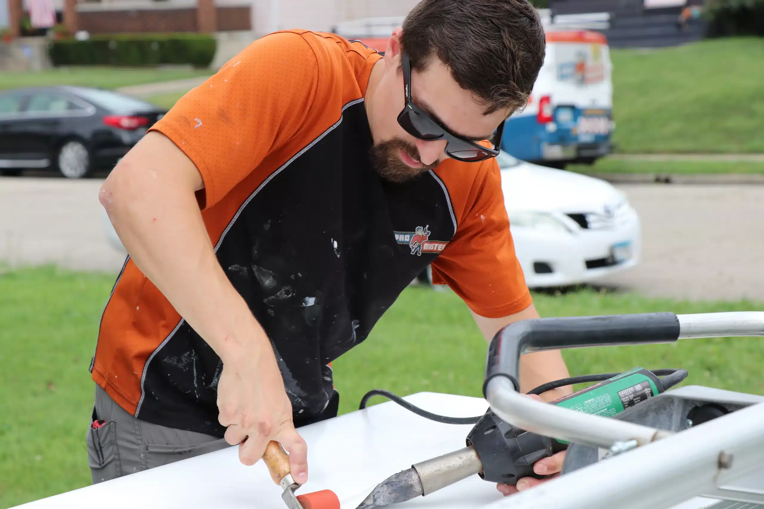 ProMaster craftsman applies heat gun to box gutter repair in Cincinnati, OH.