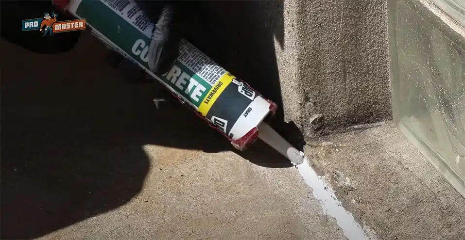 Caulking tip photograph showing ProMaster craftsman using concrete caulk.